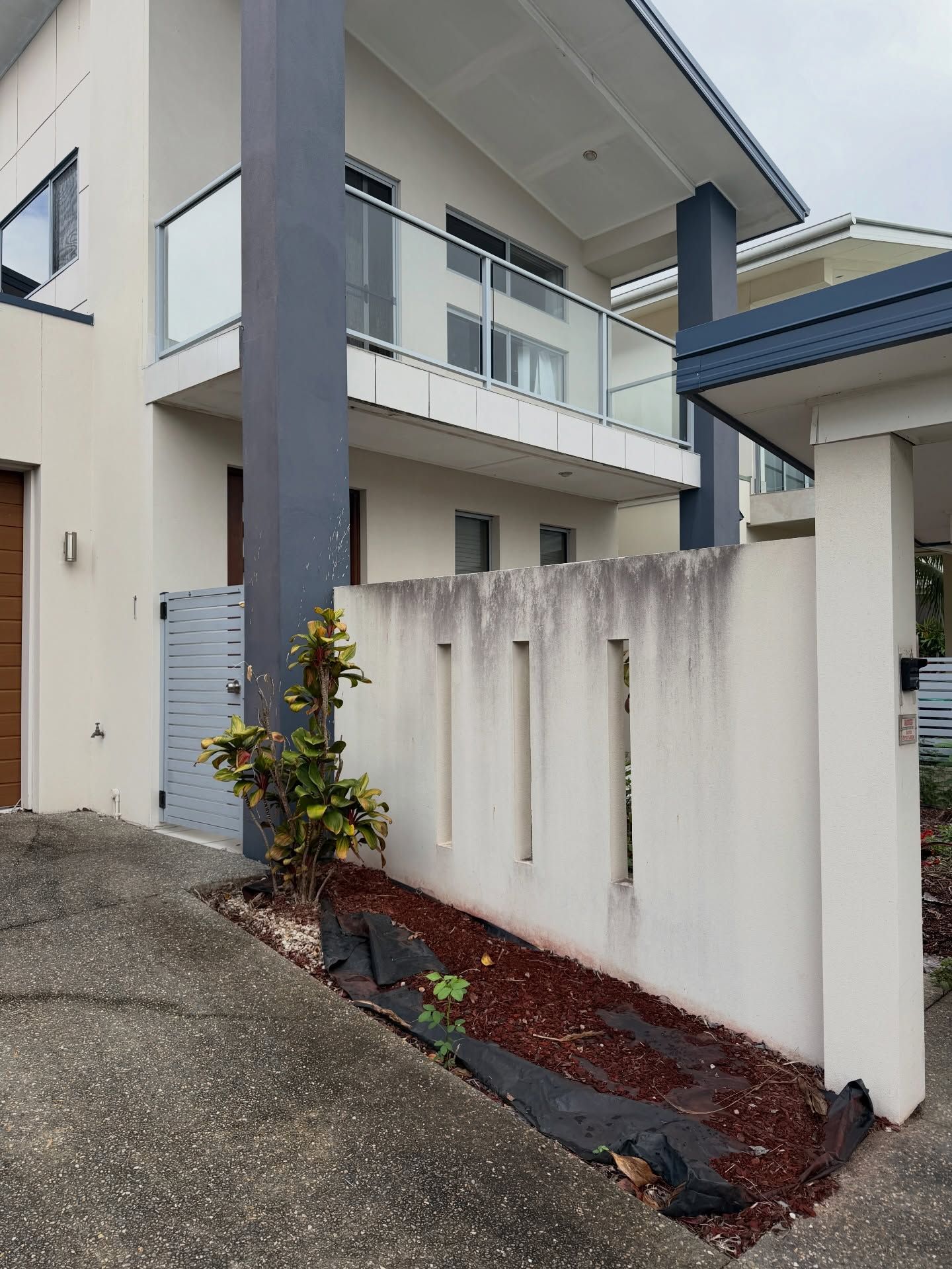 A Modern Two-story Home With a White Facade — Coastal Pressure Solutions in Oxenford, QLD