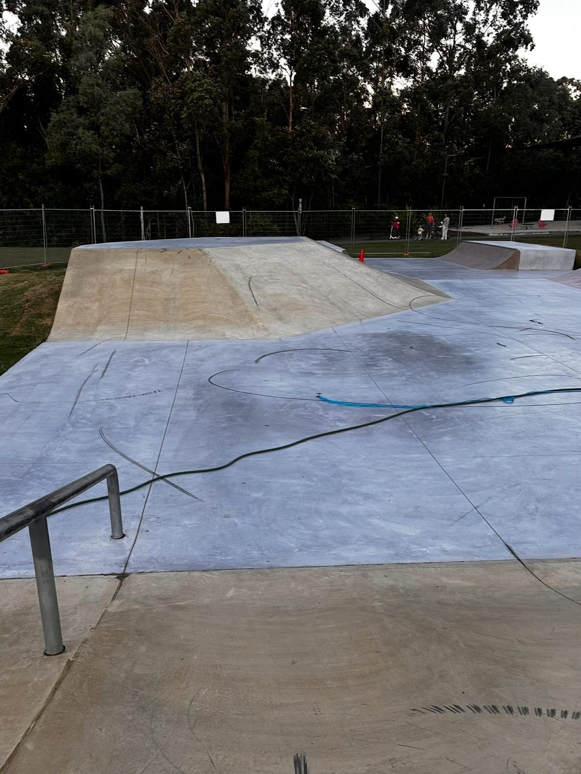 An Empty Outdoor Skatepark Featuring a Large Concrete Ramp and a Grind Rail Set — Coastal Pressure Solutions in Paradise Point, QLD