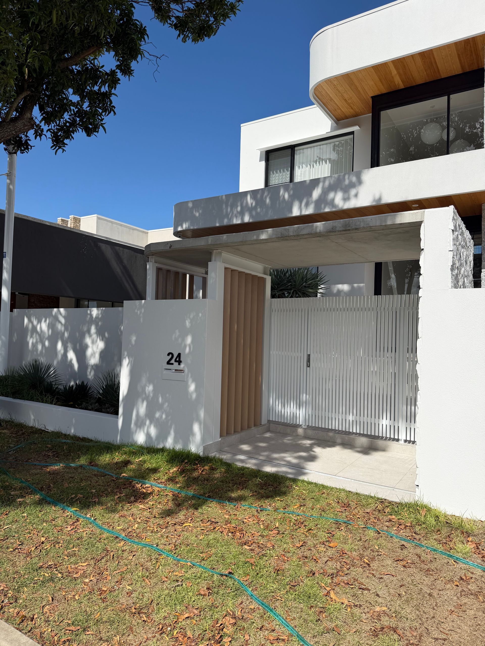 Person Washing a Dark-colored Surface — Coastal Pressure Solutions in Oxenford, QLD