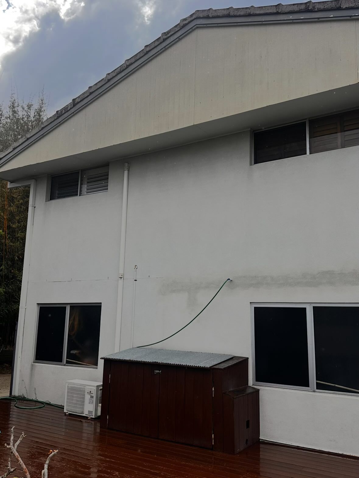 A Two-story White House Exterior With Windows — Coastal Pressure Solutions in Oxenford, QLD