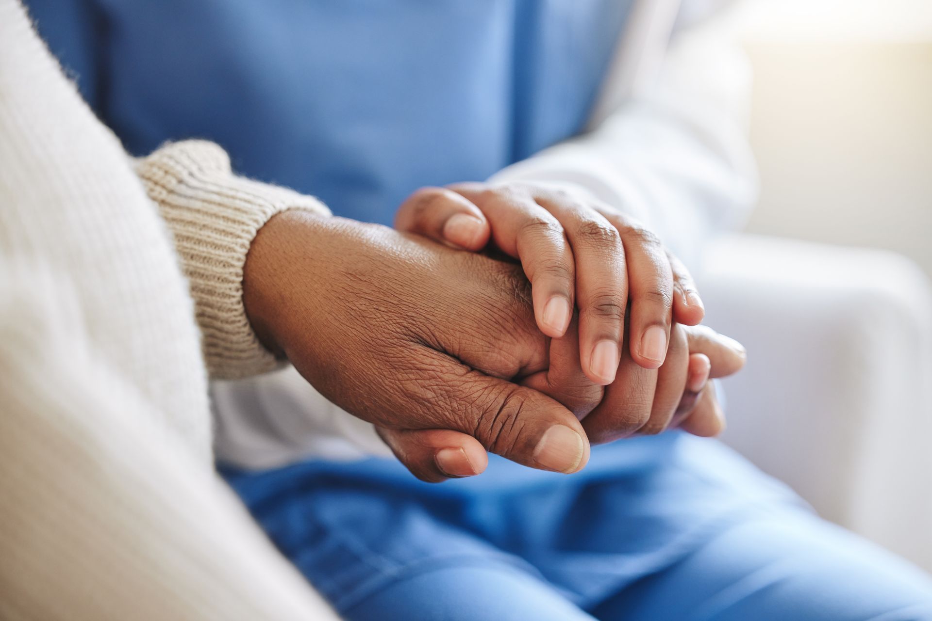 A close up of a person holding another person 's hand.
