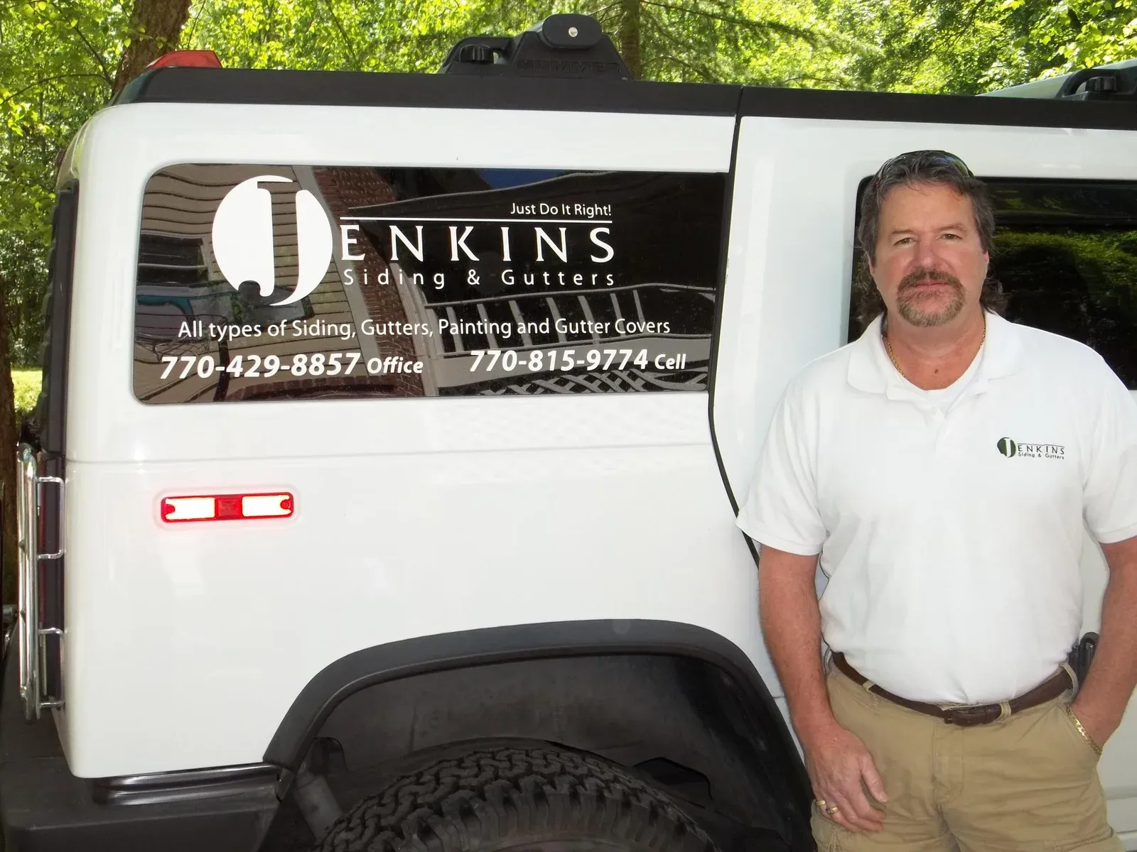 A man standing in front of a white van that says jenkins