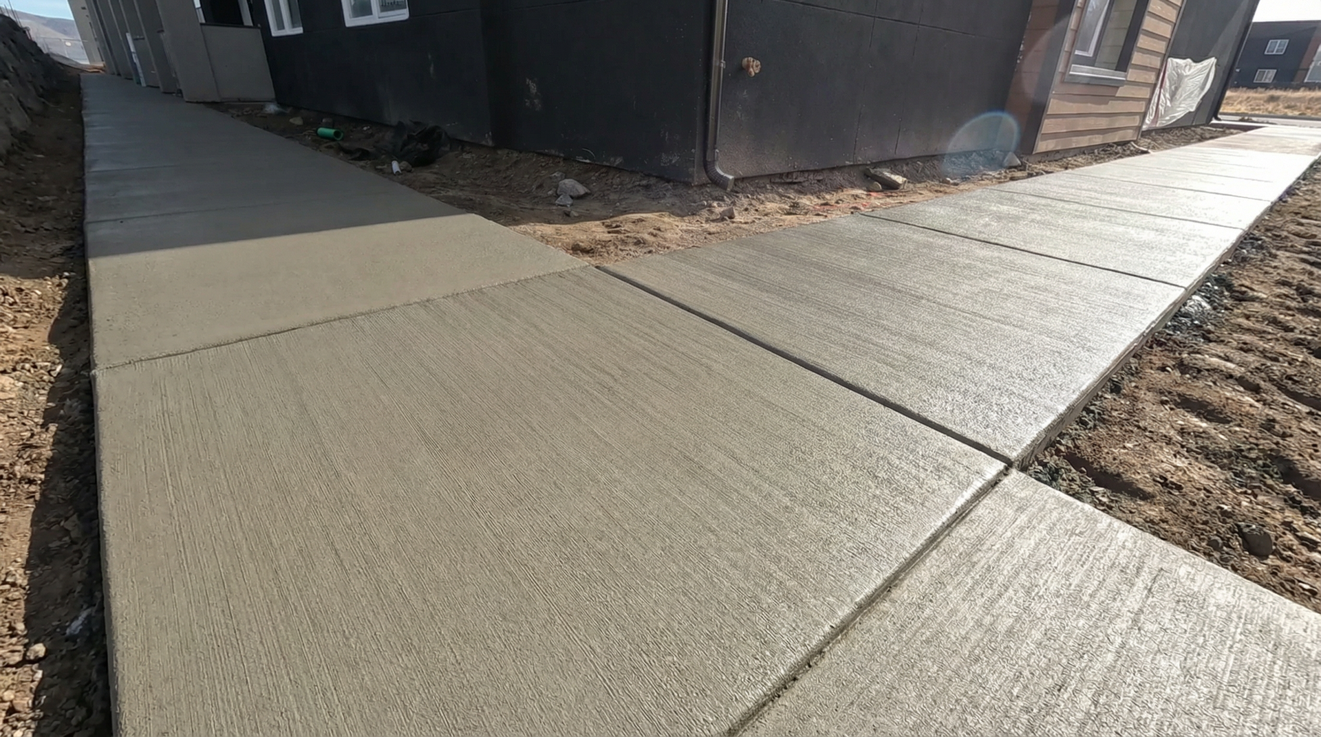 A gray concrete floor with a vase of flowers on it.