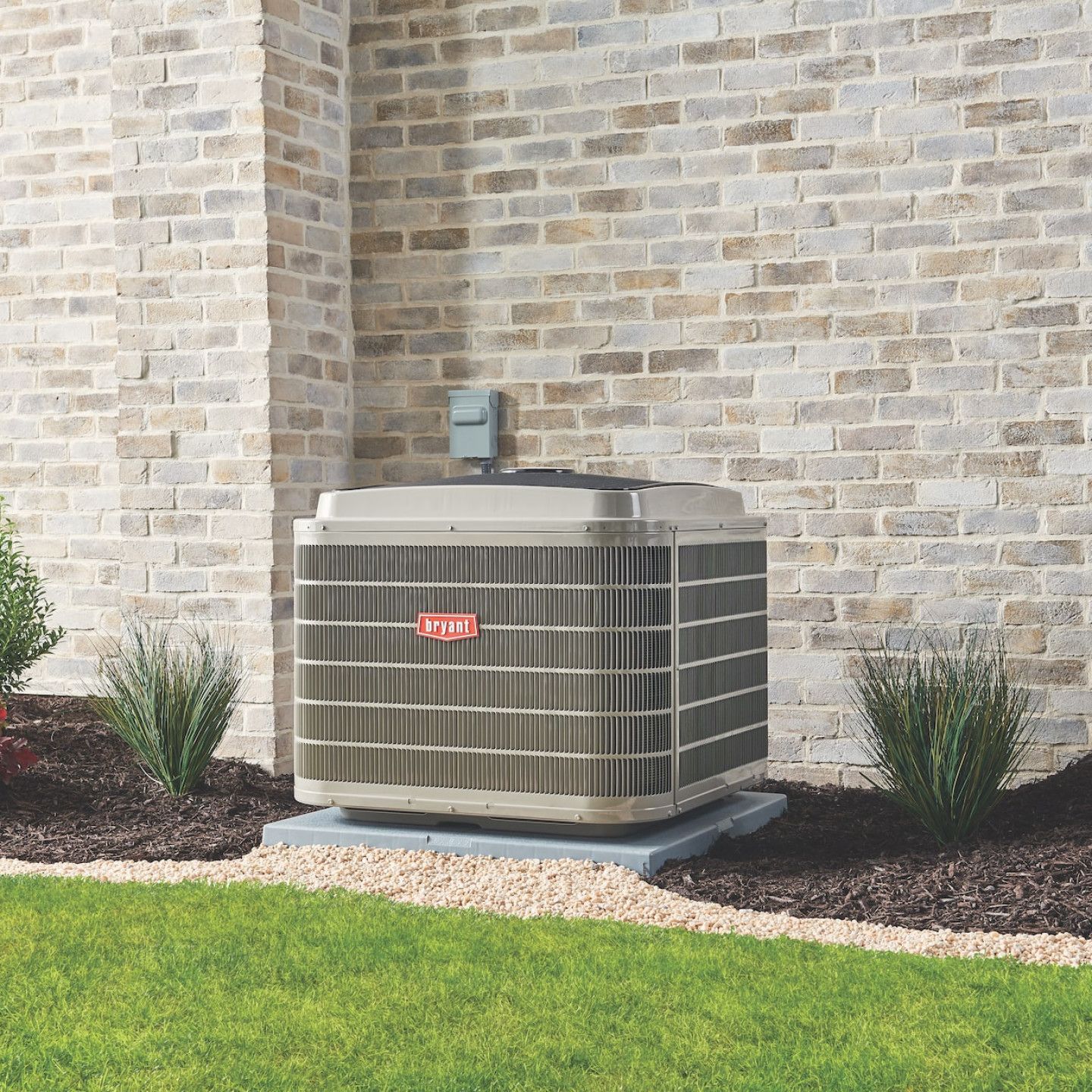 A large air conditioner is sitting on the side of a brick building