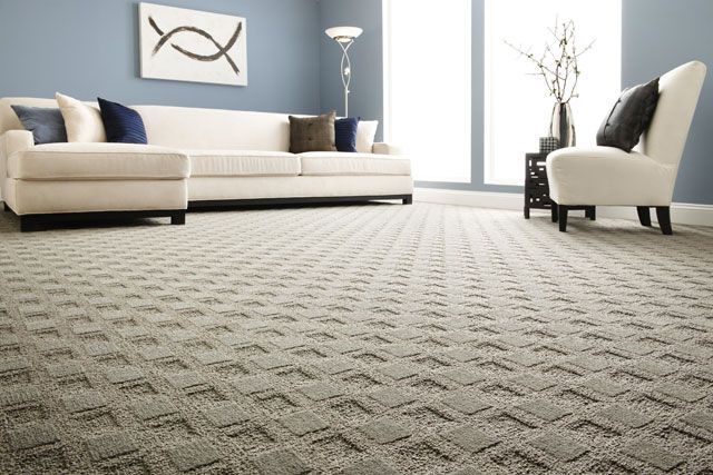 Gray textured surface with swirling patterns, resembling carpet or fabric.