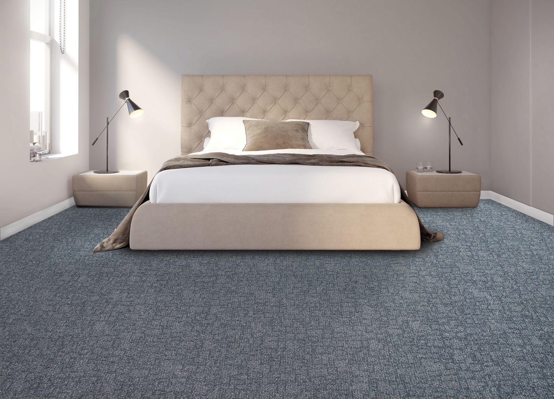 Modern bedroom with a tufted beige bed, gray walls, bedside lamps, and blue carpet