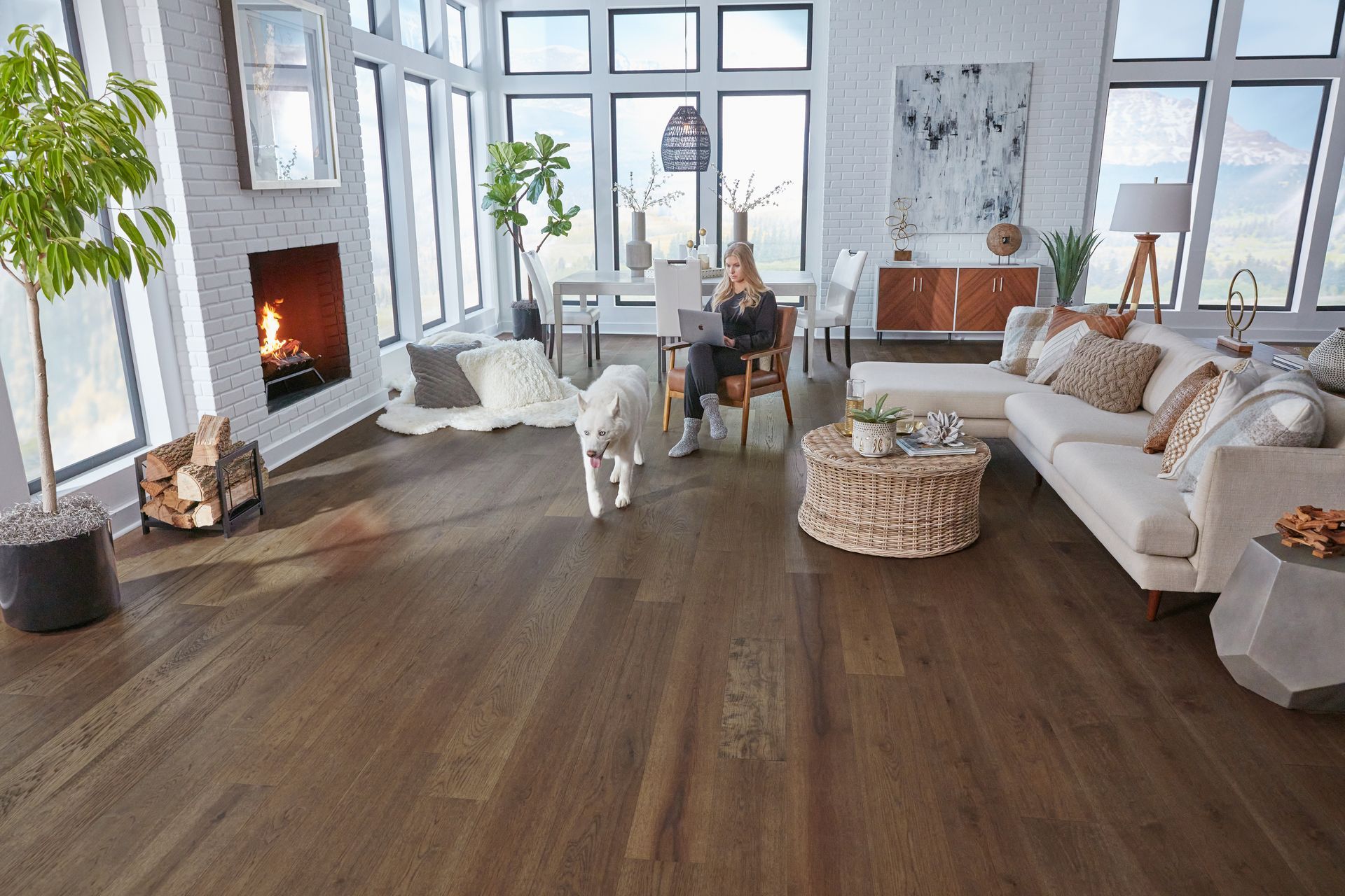 Light gray two-cushion sofa with button tufting on wooden legs on light wood floor. Light gray two-cushion sofa with button tufting on wooden legs on light wood floor.