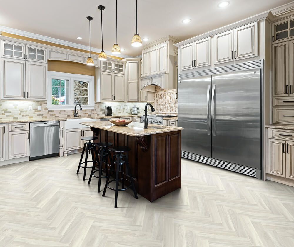 Bright modern kitchen with stainless appliances, white cabinetry, and a dark island with stools