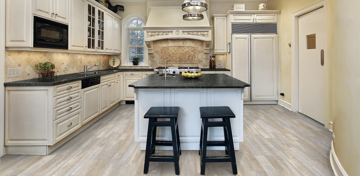 Modern kitchen with white cabinets, gray island, granite counters, and two black stools