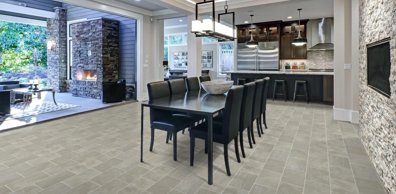 Modern dining room and kitchen with dark table, chairs, pendant lights, and large windows