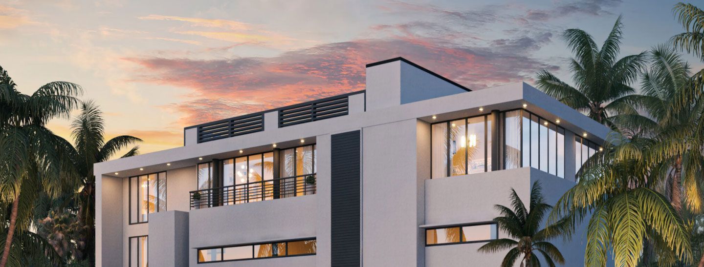 Modern white apartment building with palm trees at sunset