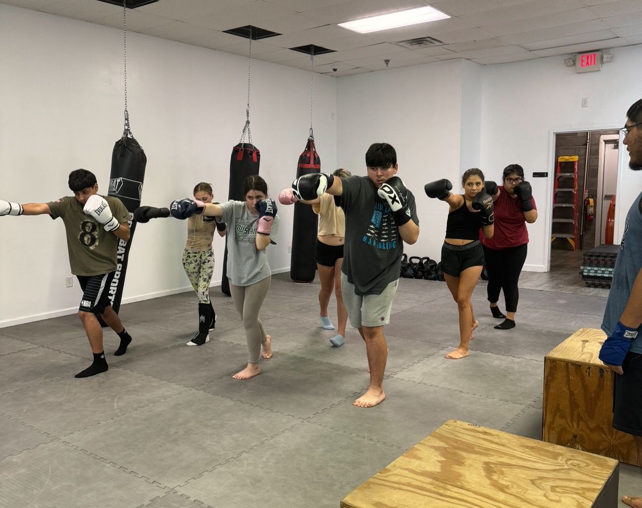 A group of people are boxing in a gym.