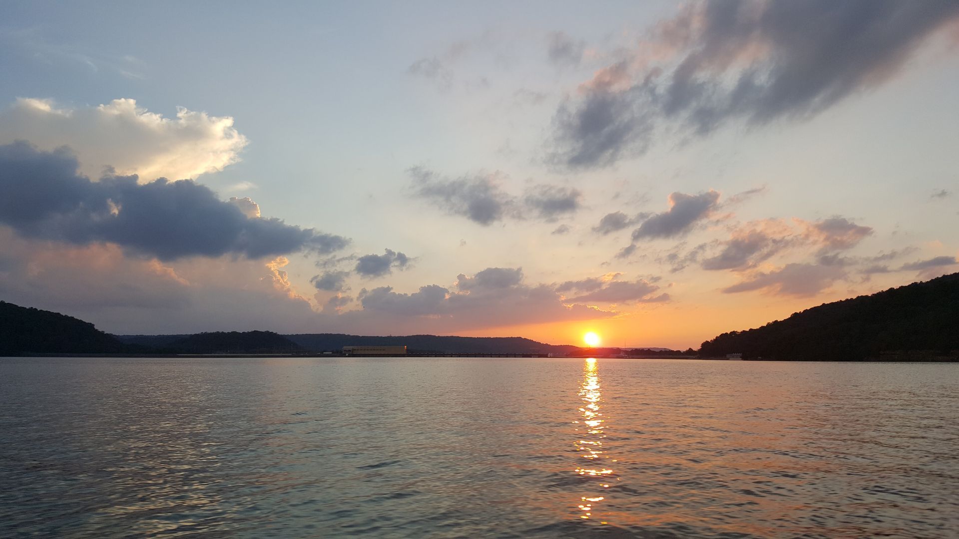 The sun is setting over a large body of water