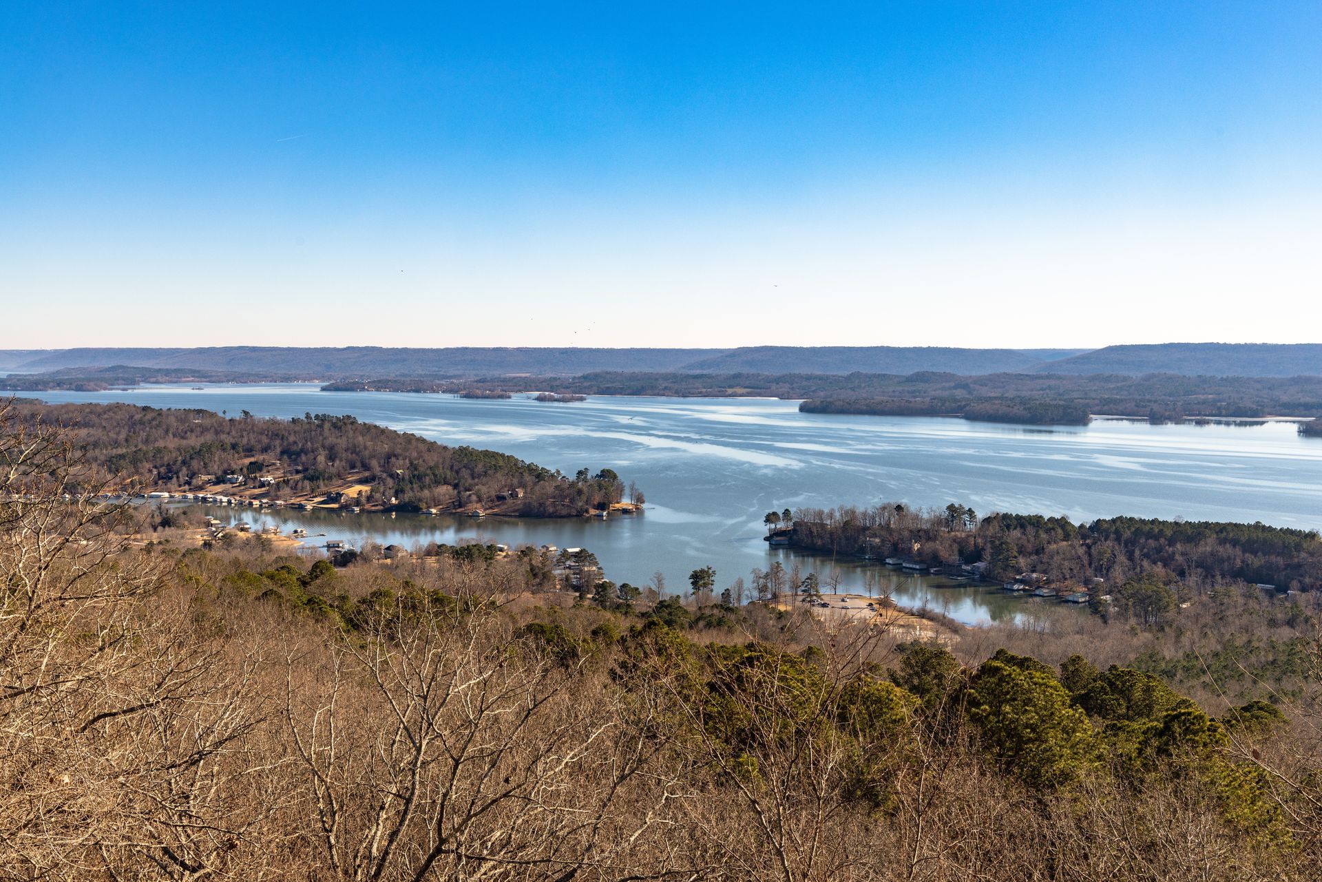 An aerial view of a large body of water surrounded by trees.