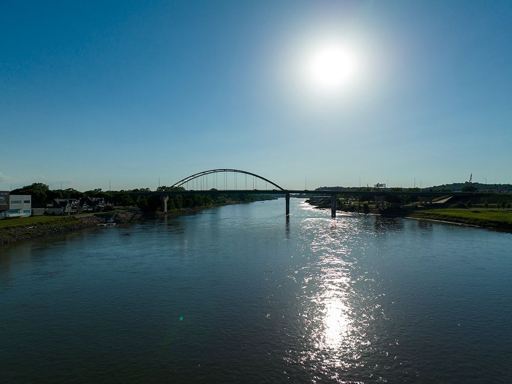 A bridge over a river with the sun shining on it