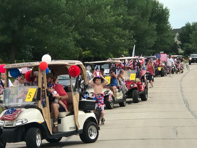 A row of golf carts with the number 5 on the front