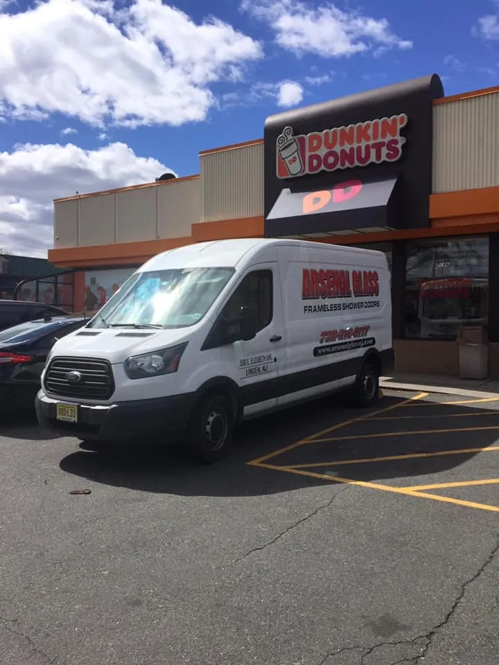 Arsenal Glass mobile commercial service van parked in front of a Dunkin' Donuts location in New Jersey.