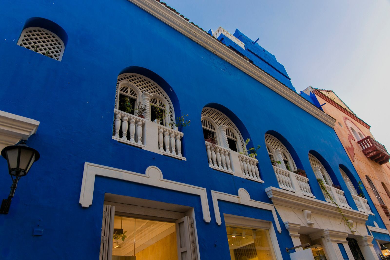 Blue building with arched windows and white balconies; Cartagena, Colombia.