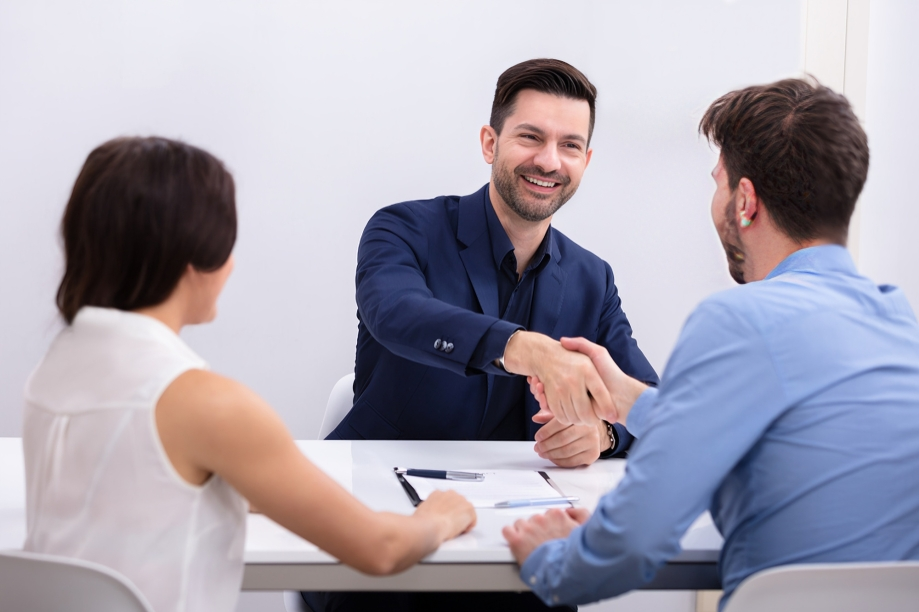 Lawyer Shakes Hands With a Client Across a Desk — Australian Employee Lawyers in Broadbeach Waters, QLD