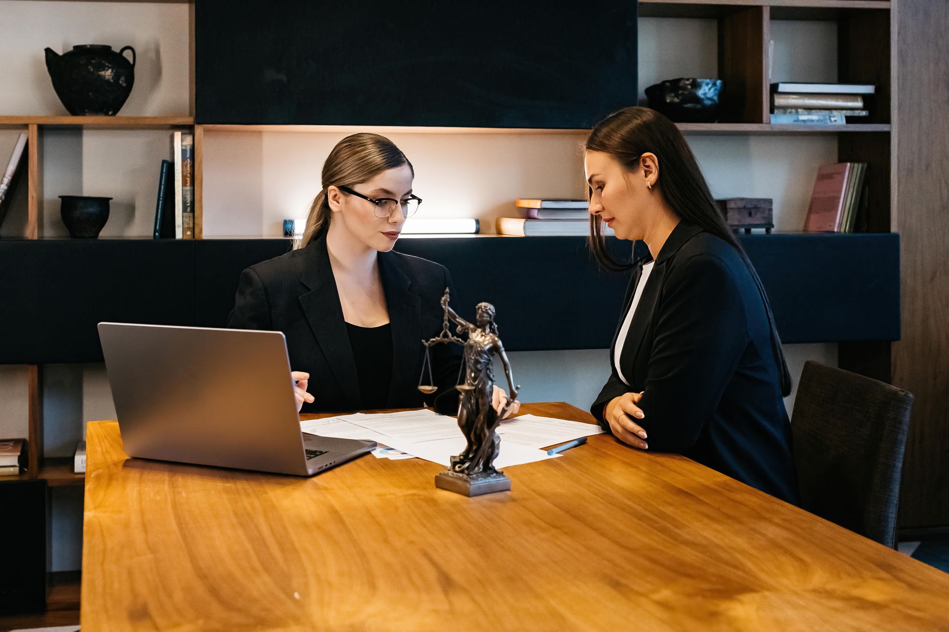 Lawyer Talking to Her Client at a Wooden Desk — Australian Employee Lawyers in Broadbeach Waters, QLD
