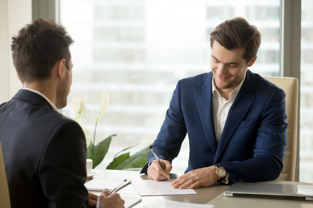 Two Professionals in Business Suits Sit Across From Each Other — Australian Employee Lawyers in Broadbeach Waters, QLD
