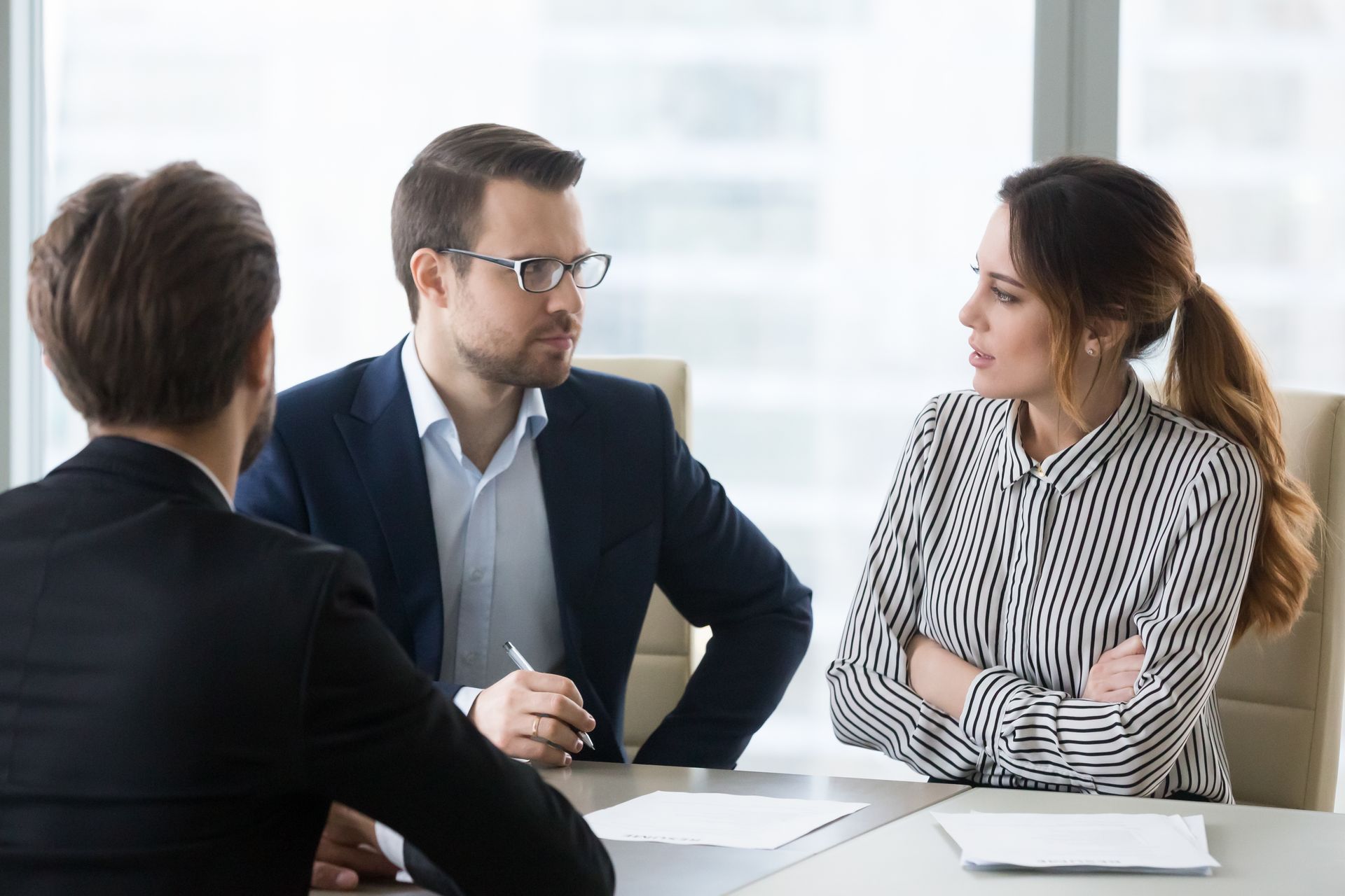 Three Professionals in Business Attire Sit at a Table in a Bright Office — Australian Employee Lawyers in Broadbeach Waters, QLD