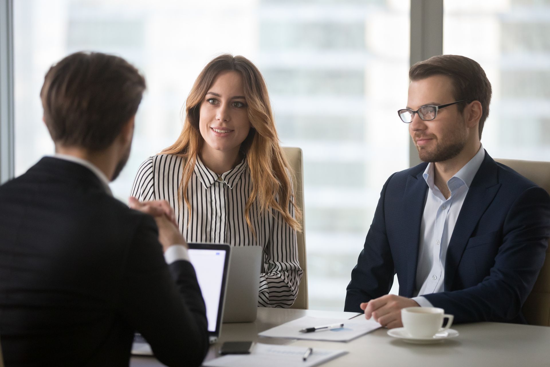 Three Professionals in Business Attire Sit Around a Desk — Australian Employee Lawyers in Broadbeach Waters, QLD