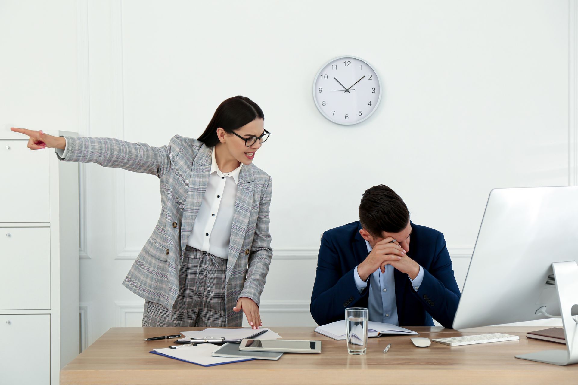 A Professional in a Plaid Blazer Points Toward an Exit — Australian Employee Lawyers in Broadbeach Waters, QLD