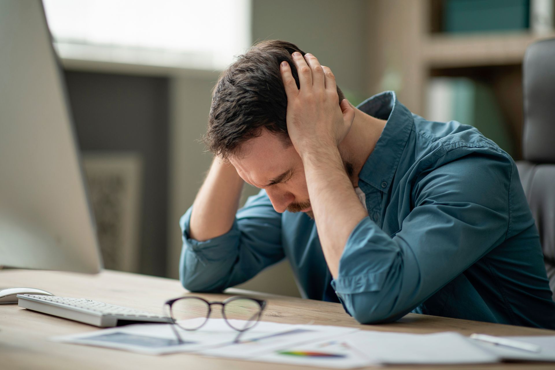Employee Looking Stressed or Overwhelmed While Working at a Computer — Australian Employee Lawyers in Brisbane, QLD