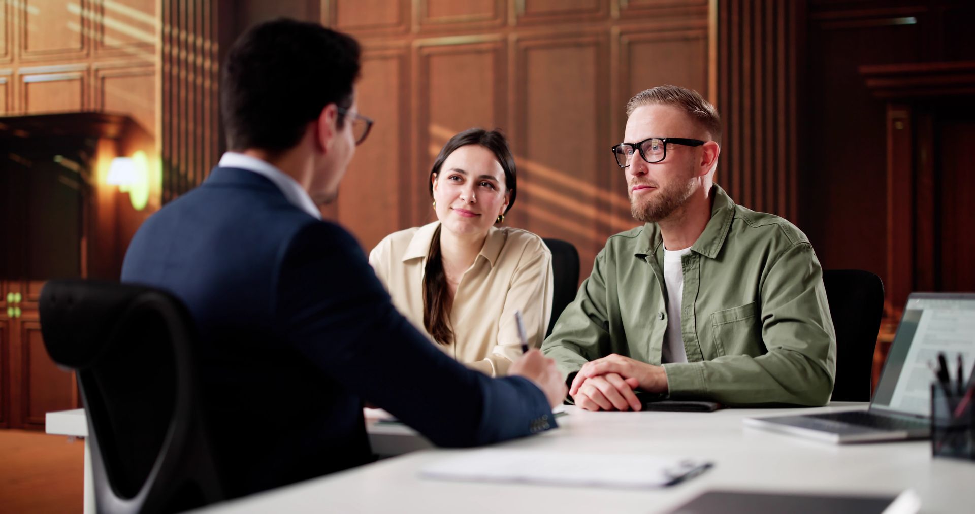A Professional Consultant Sits at a Desk Across From Two Employee — Australian Employee Lawyers in Broadbeach Waters, QLD