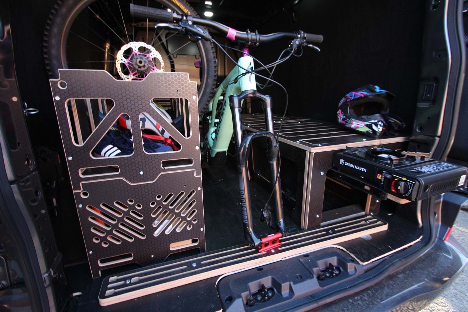Custom PC build in a car trunk, with a water-cooled setup and glowing RGB components