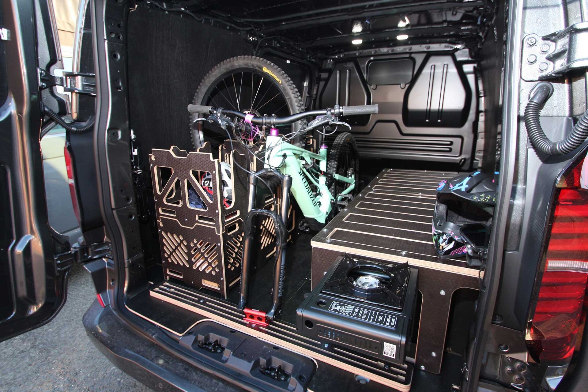 Interior of a van converted for a wheelchair user, with a ramp and secured wheelchair area