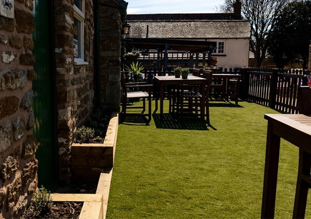 After installation of artificial grass a café in installation of artificial grass a café in Yaxley, Peterborough