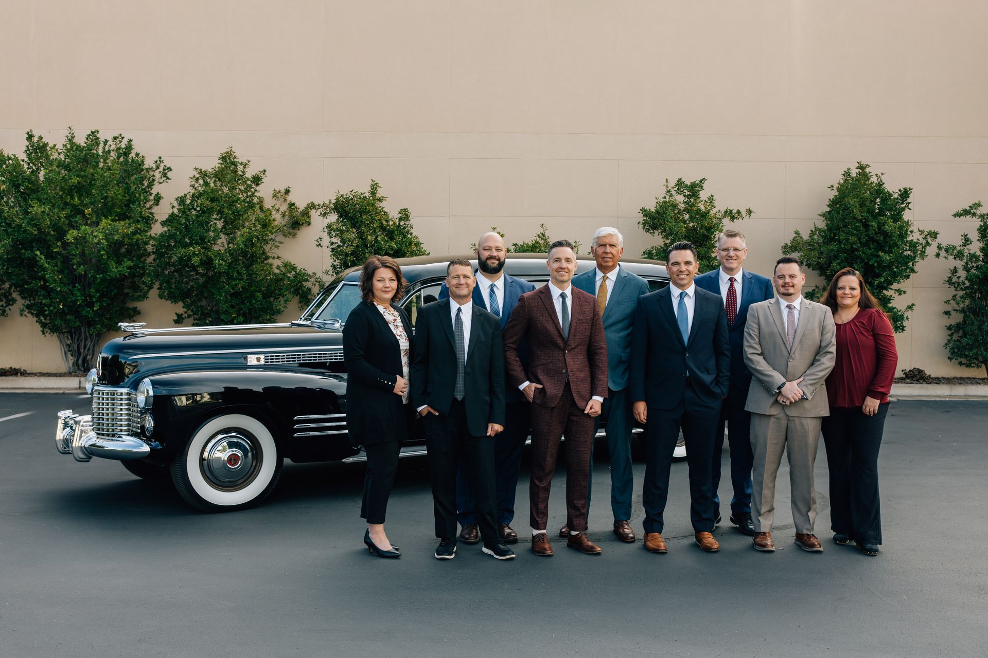 Staff members of Allen Mortuaries in front of hearse at facilities in Logan, UT 84321