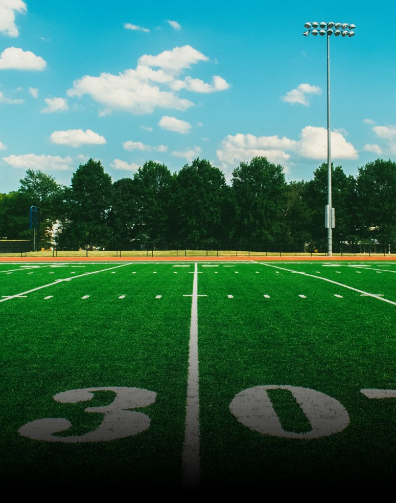 Crew installing synthetic sports turf at a training facility