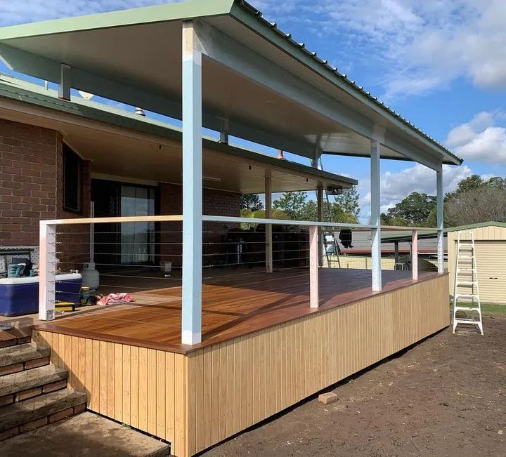 A House With a Wooden Deck and Stairs in Front of It — Better Built Patios & Decking in Wollongbar, NSW