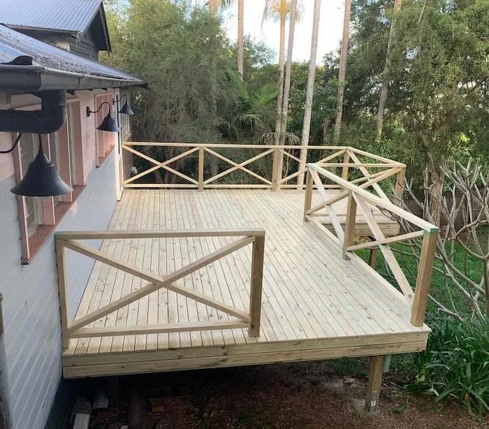 A Large Wooden Deck With a Railing on the Side of a House — Better Built Patios & Decking in Wollongbar, NSW