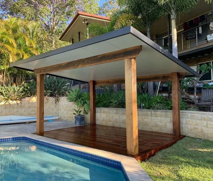 A Wooden Pavilion is Sitting Next to a Swimming Pool — Better Built Patios & Decking in Wollongbar, NSW