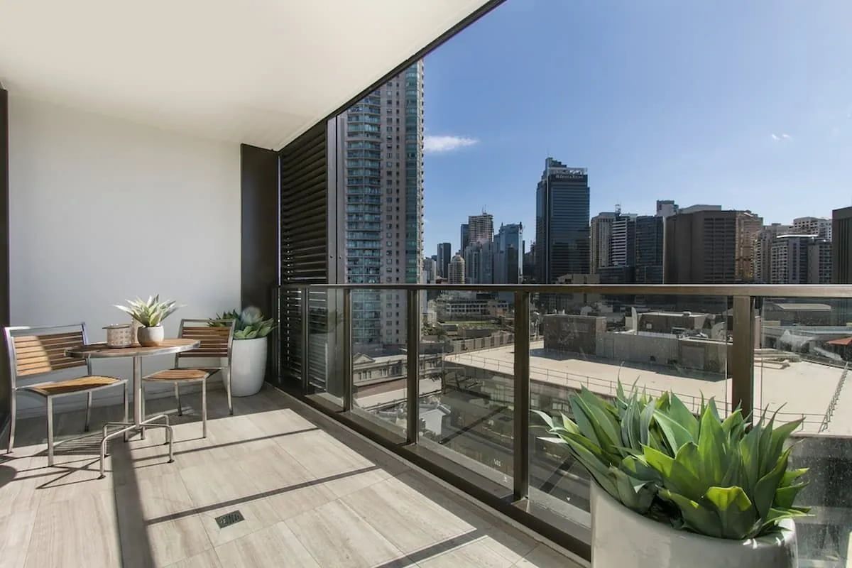 A Balcony With a Table and Chairs and a View of the City — Better Built Patios & Decking in Wollongbar, NSW