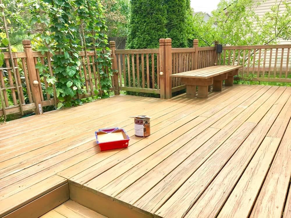 A Wooden Deck With a Bench and a Can of Paint on It — Better Built Patios & Decking in Byron Bay, NSW