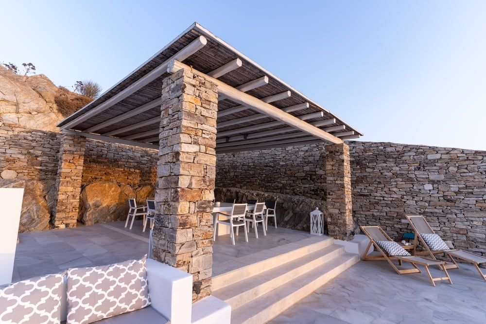 There is a Pergola With a Table and Chairs Underneath It — Better Built Patios & Decking in Ballina, NSW