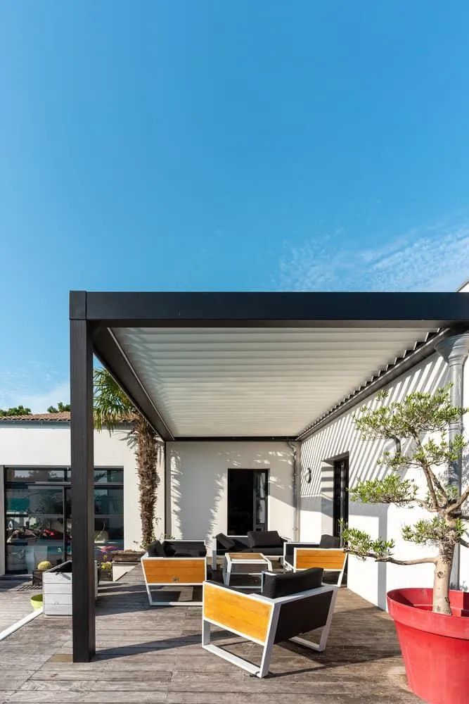 A back deck area with outdoor furniture and pergola — Better Built Patios & Decking in Wollongbar, NSW