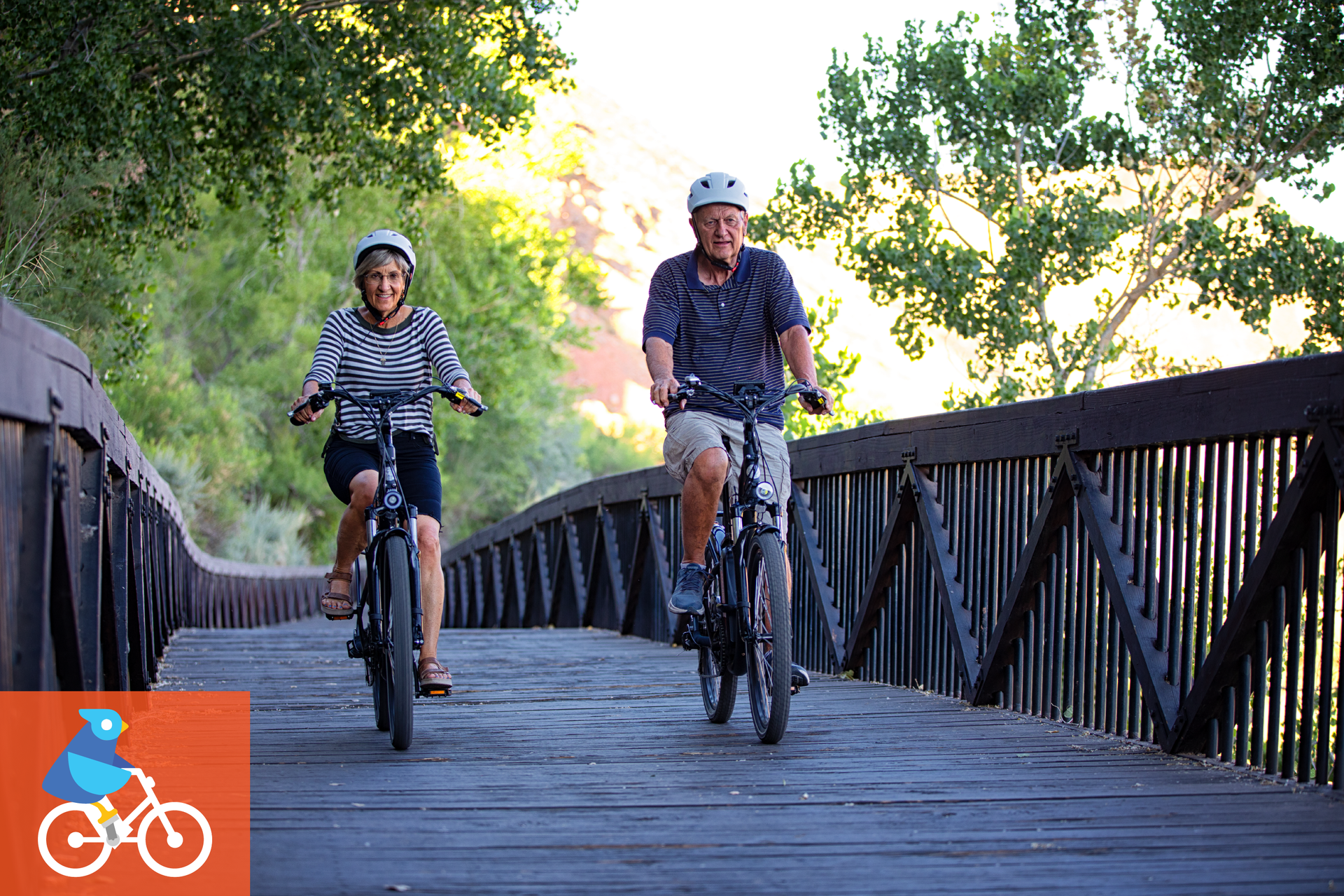Two People riding ebikes on a wooden bridge