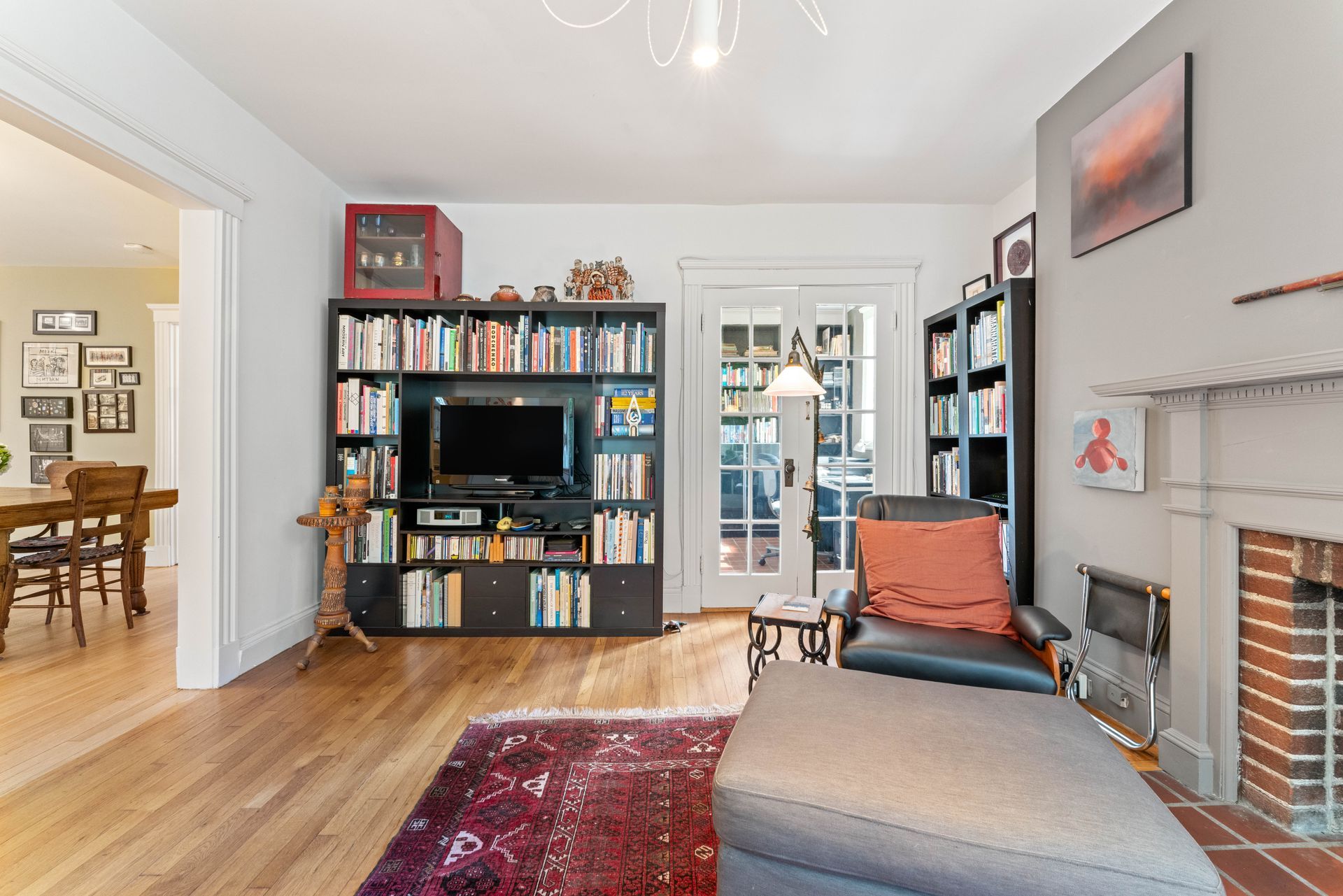 Another view of living room with bookcase
