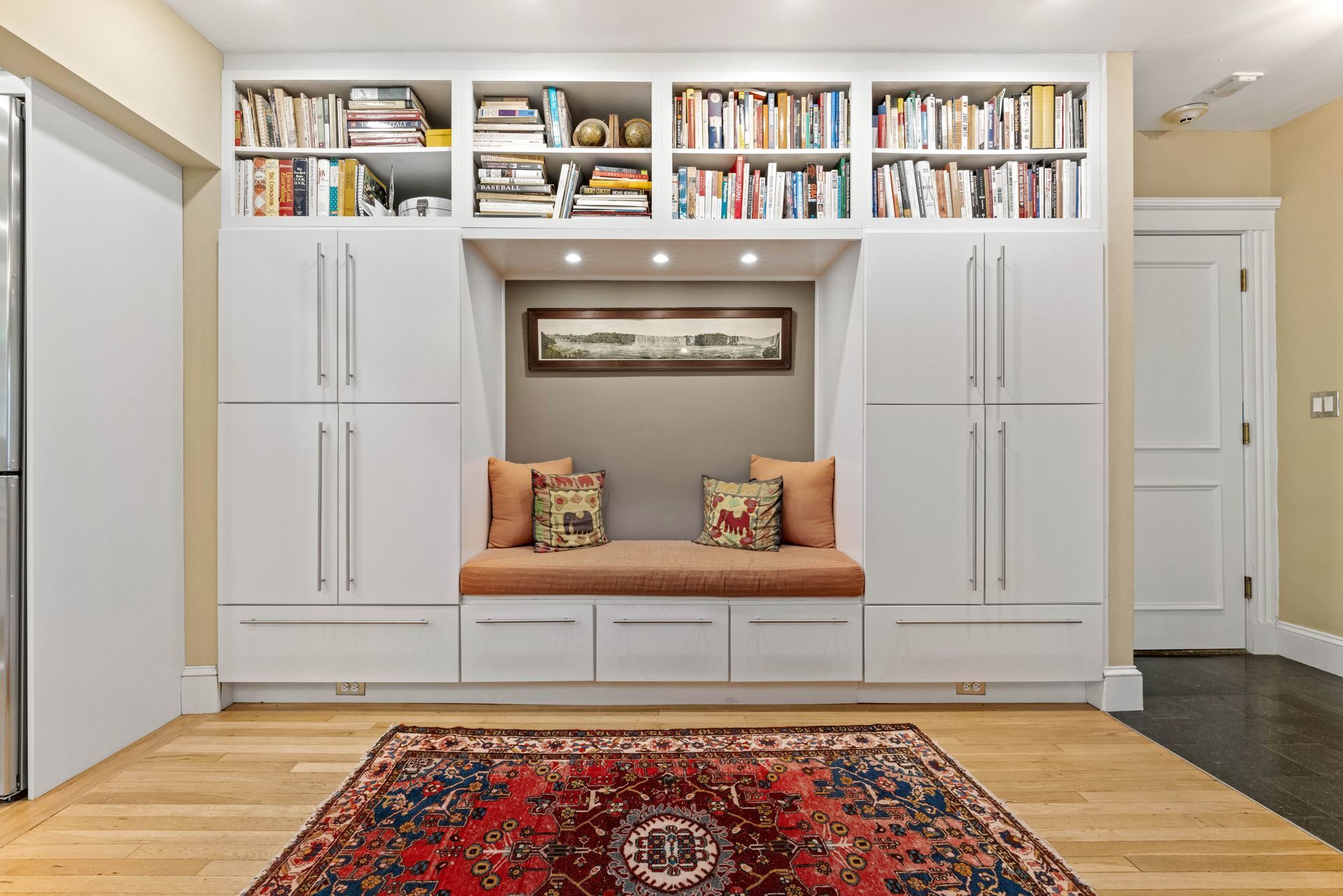 Closeup of reading nook with built-in cabinets and book shelves