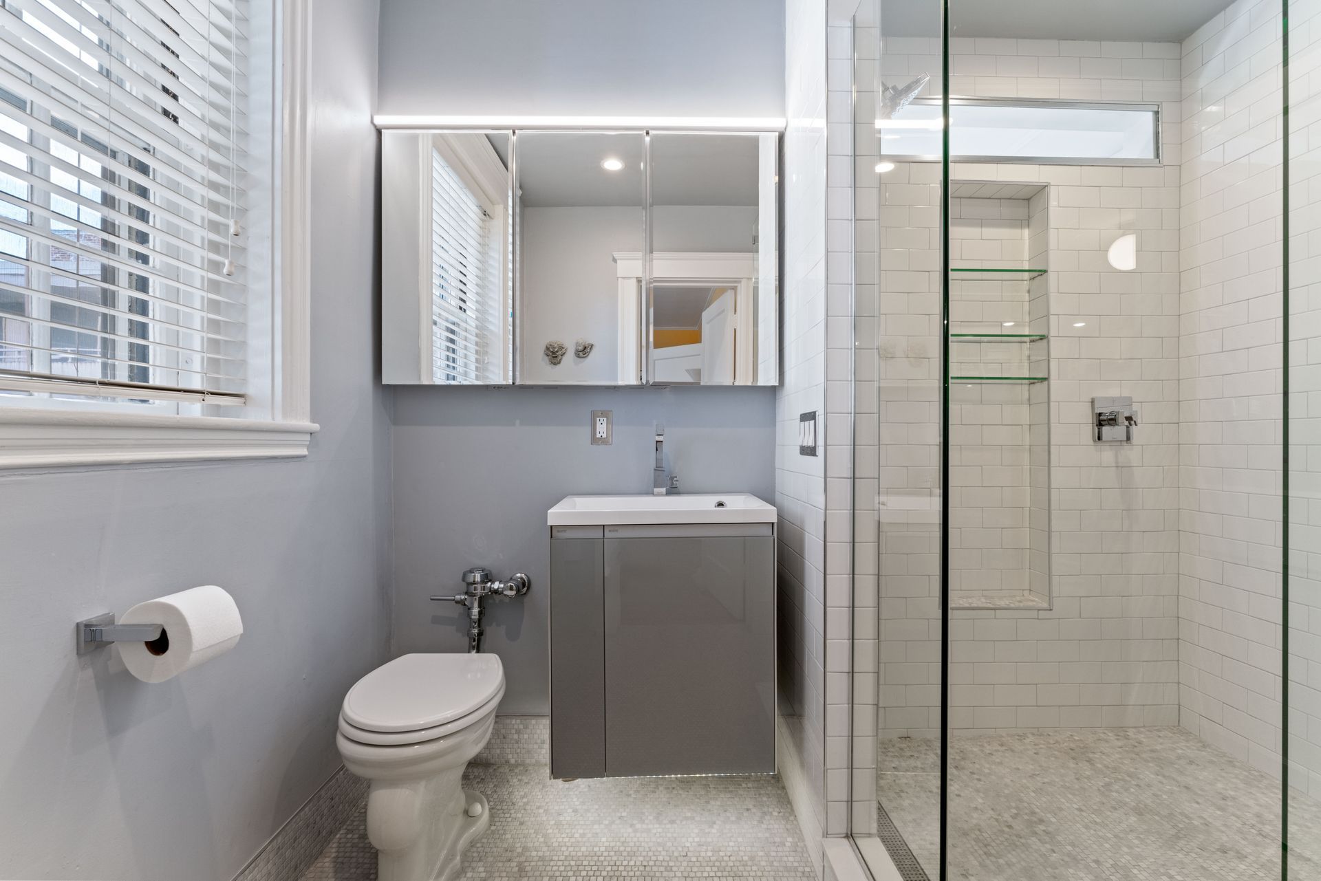 Bathroom with walk-in shower, modern vanity and window