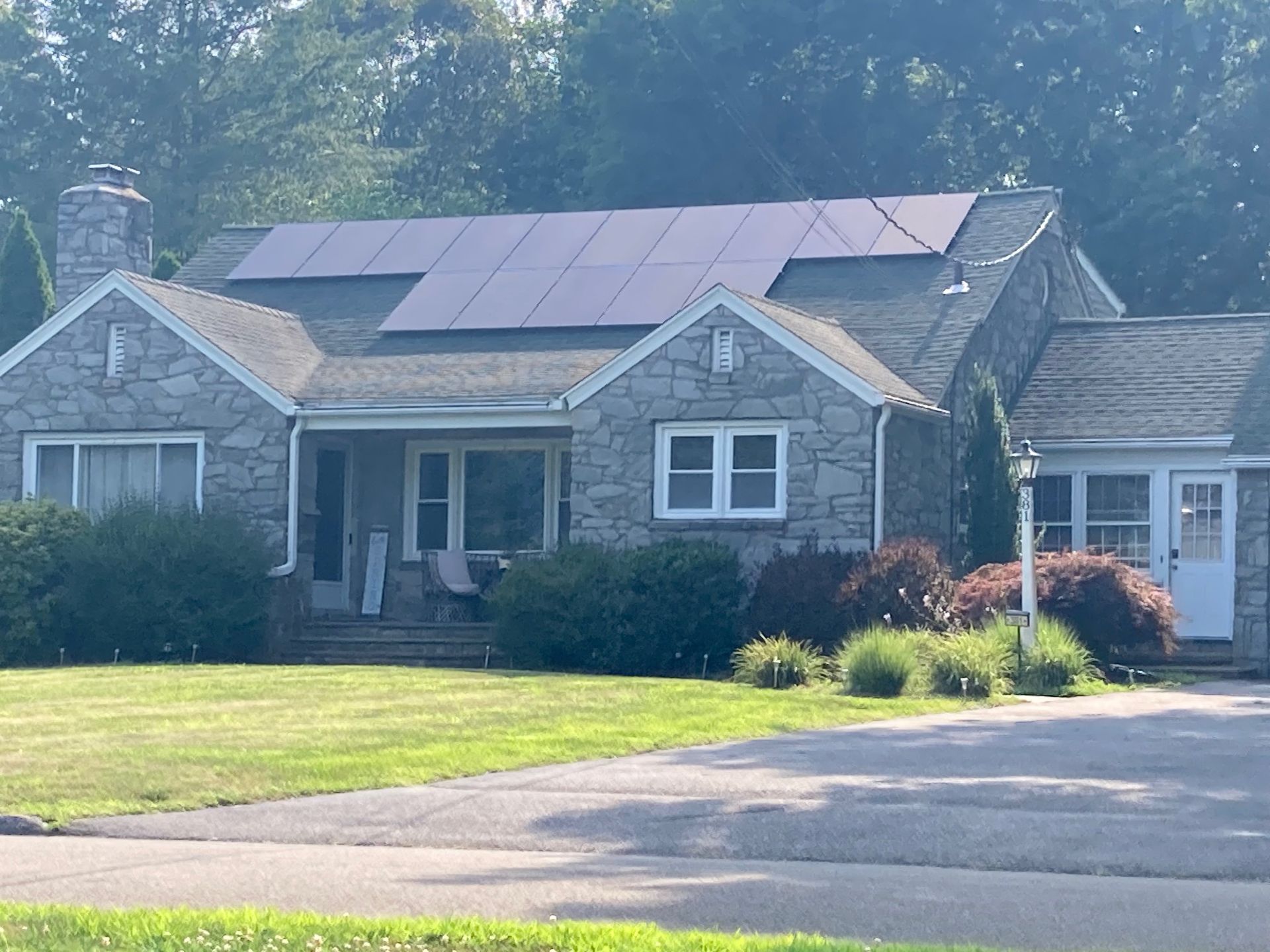 A stone house with solar panels on the roof