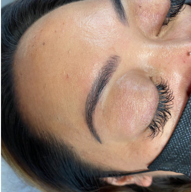 Close-up of freshly microbladed eyebrows showing natural, hair-like strokes and defined shape
