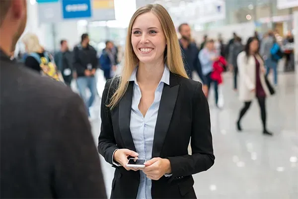 Professional networking conversation at a trade fair or business event.