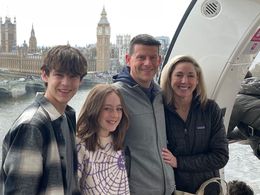 A family is posing for a picture on a boat in london.
